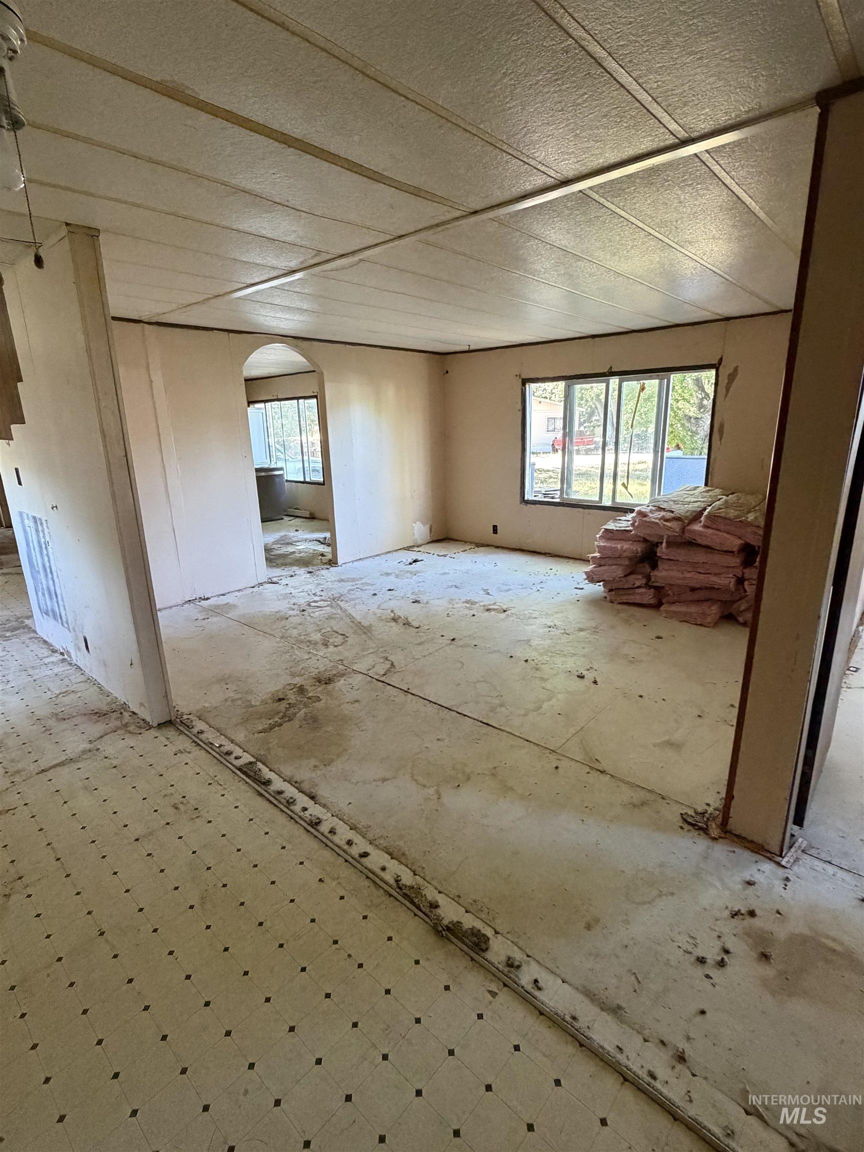 770 Dolson Lane Eagle, ID 83616 - Photo 7 of 11 Interior space featuring a dropped ceiling system, neutral-toned walls, and multiple windows