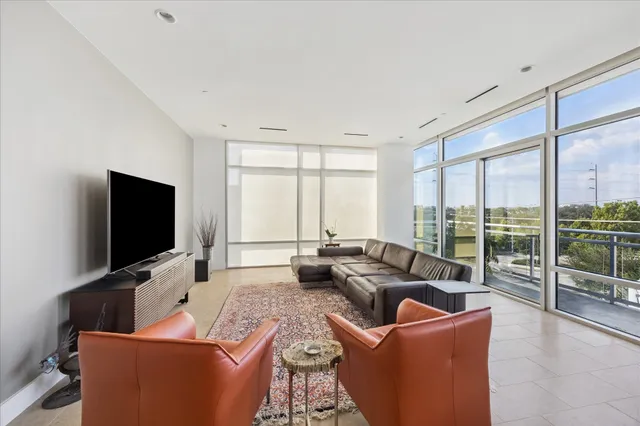 a very nice looking room with many windows and furniture