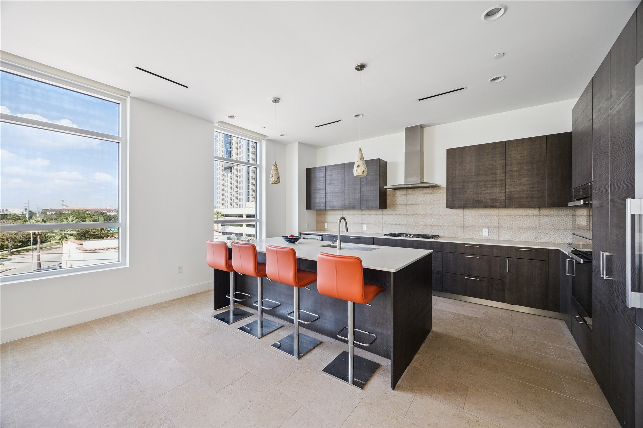 3331 D'Amico Street, Unit 404 Houston, TX 77019 - Photo 8 of 22 a kitchen with stainless steel appliances granite countertop a stove top oven a sink dishwasher a dining table and chairs with wooden floor