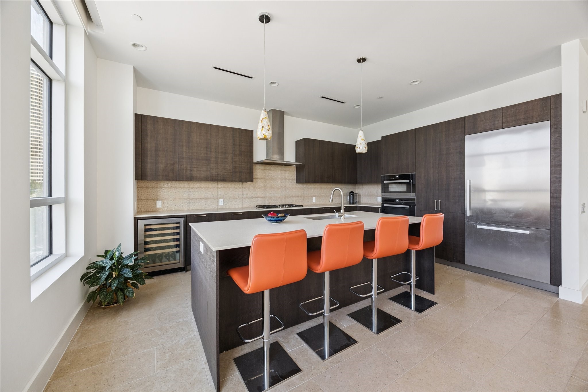 3331 D'Amico Street, Unit 404 Houston, TX 77019 - Photo 9 of 22 a kitchen with a table chairs refrigerator and microwave