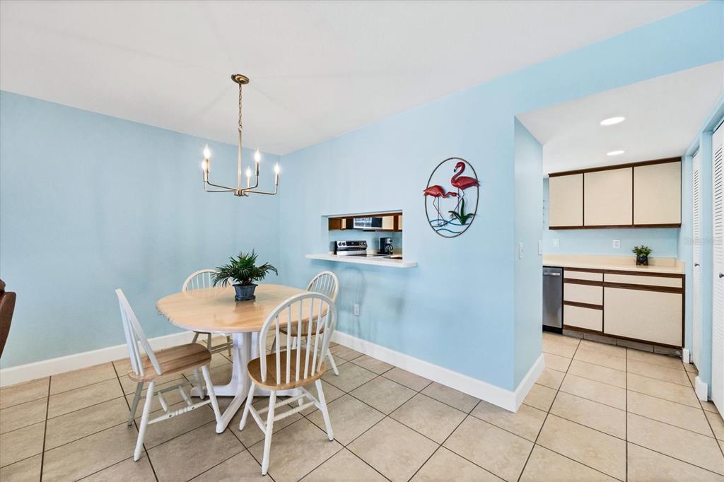 1531 Placida Road, Unit 202 Englewood, FL 34223 - Photo 11 of 44 a view of a dining room with furniture wooden floor and a chandelier