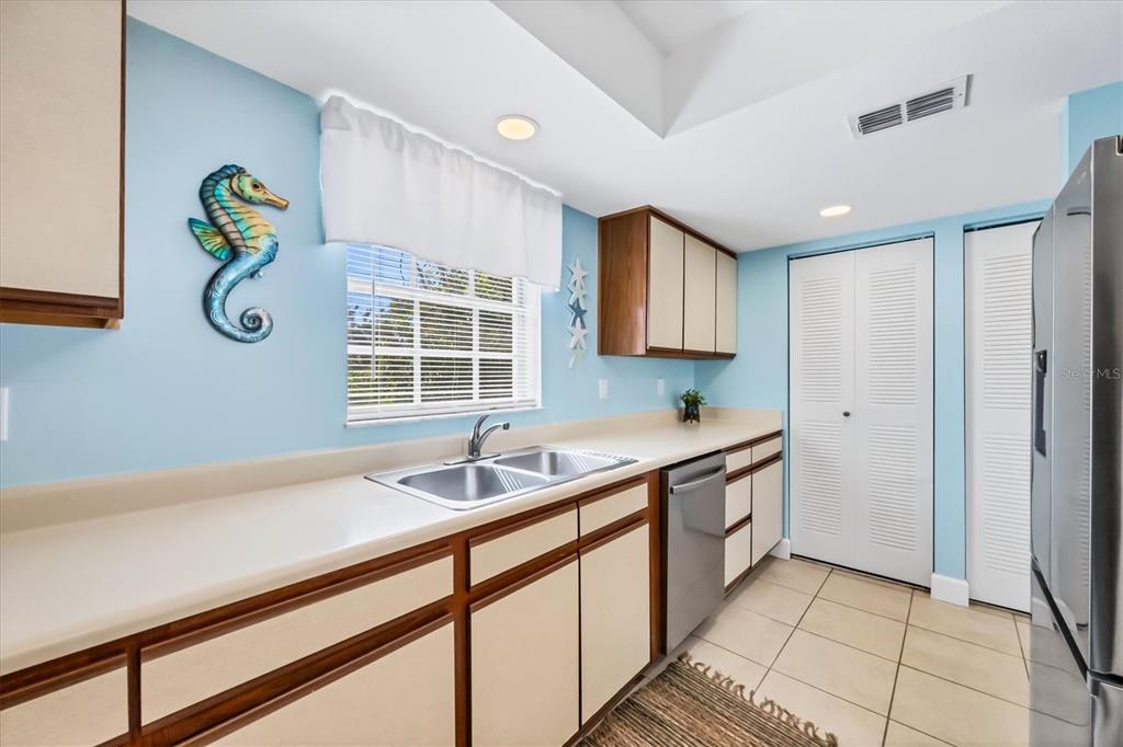 1531 Placida Road, Unit 202 Englewood, FL 34223 - Photo 16 of 44 a kitchen with a sink and a window