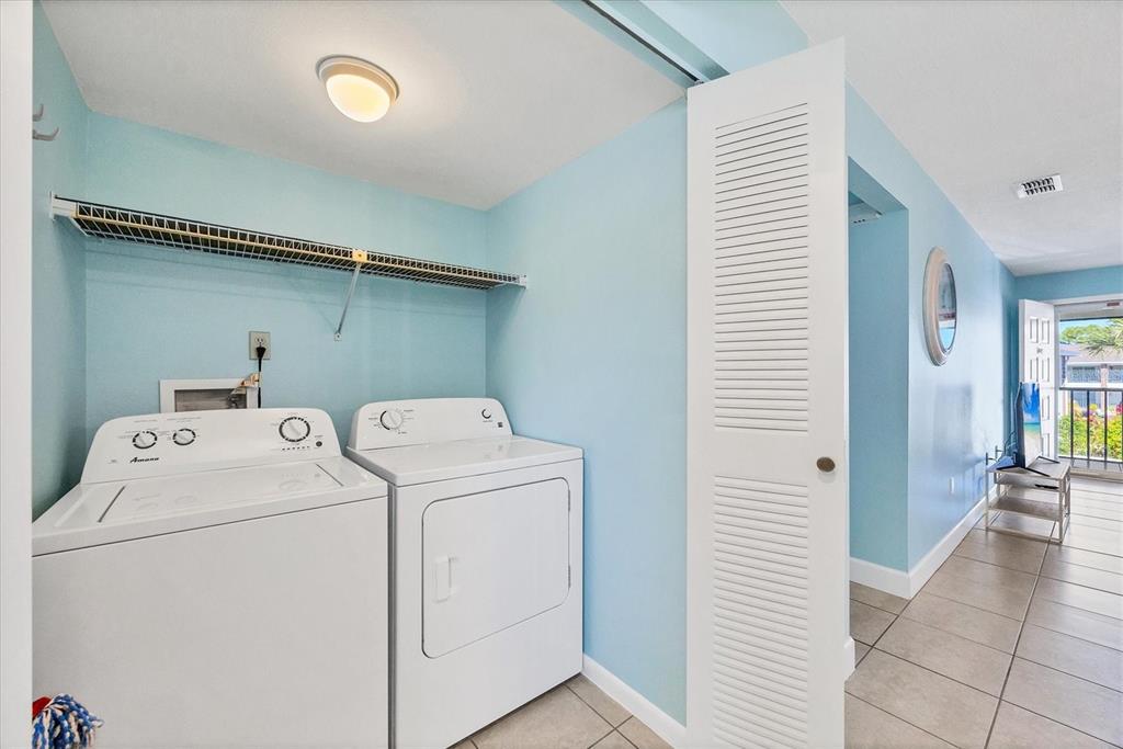 1531 Placida Road, Unit 202 Englewood, FL 34223 - Photo 19 of 44 a view of storage and utility room with washer and dryer