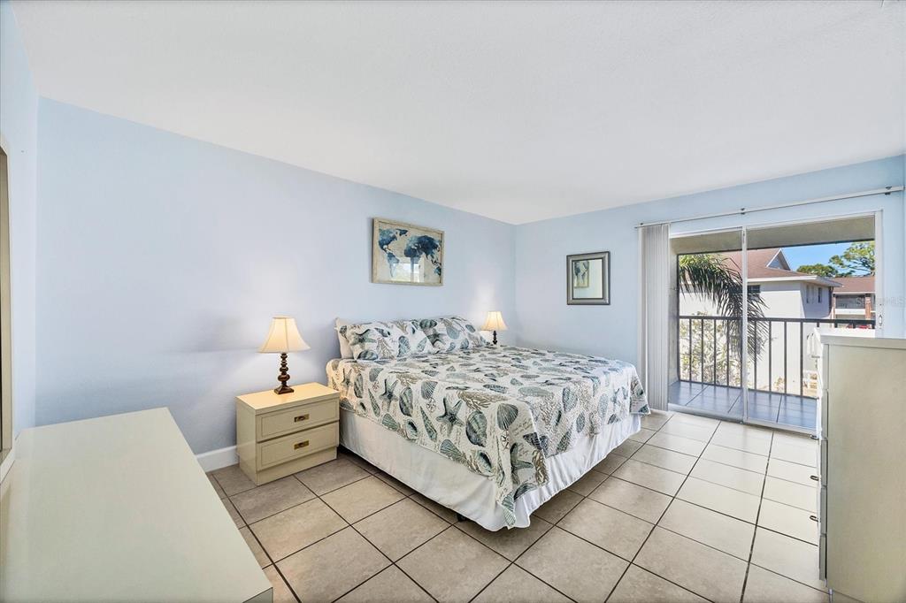 1531 Placida Road, Unit 202 Englewood, FL 34223 - Photo 20 of 44 a bed room with a bed and a lamp