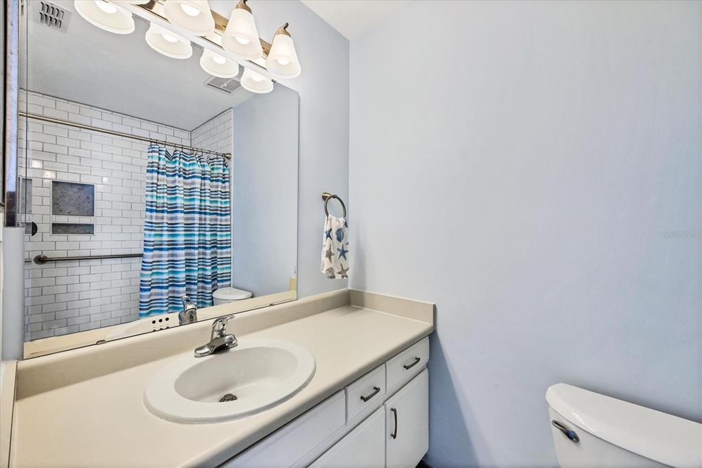 1531 Placida Road, Unit 202 Englewood, FL 34223 - Photo 24 of 44 a bathroom with a sink vanity granite and toilet