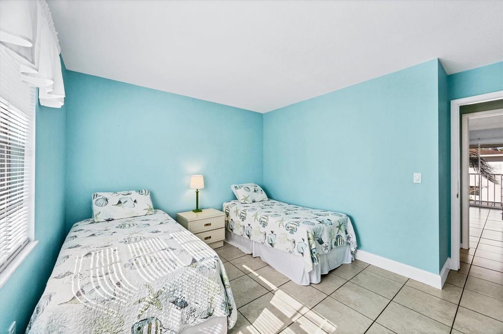 1531 Placida Road, Unit 202 Englewood, FL 34223 - Photo 26 of 44 a bedroom with two beds and a window