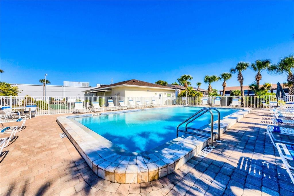 1531 Placida Road, Unit 202 Englewood, FL 34223 - Photo 30 of 44 a view of a swimming pool with an outdoor seating