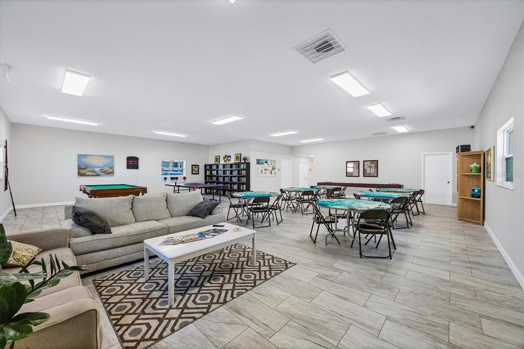 1531 Placida Road, Unit 202 Englewood, FL 34223 - Photo 33 of 44 a living room with furniture and a dining table with wooden floor