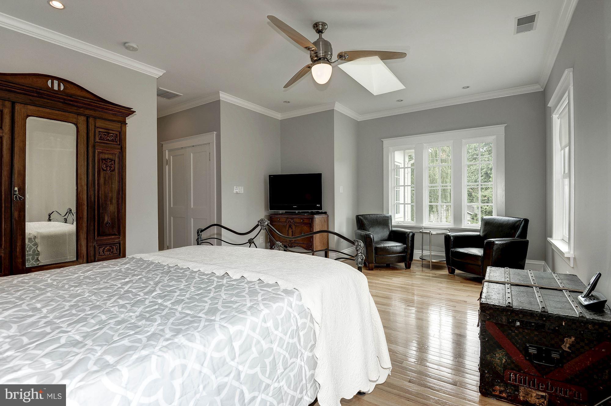 1213 Buchanan Street McLean, VA 22101 - Photo 15 of 30 a spacious bedroom with a bed a couch and a chandelier