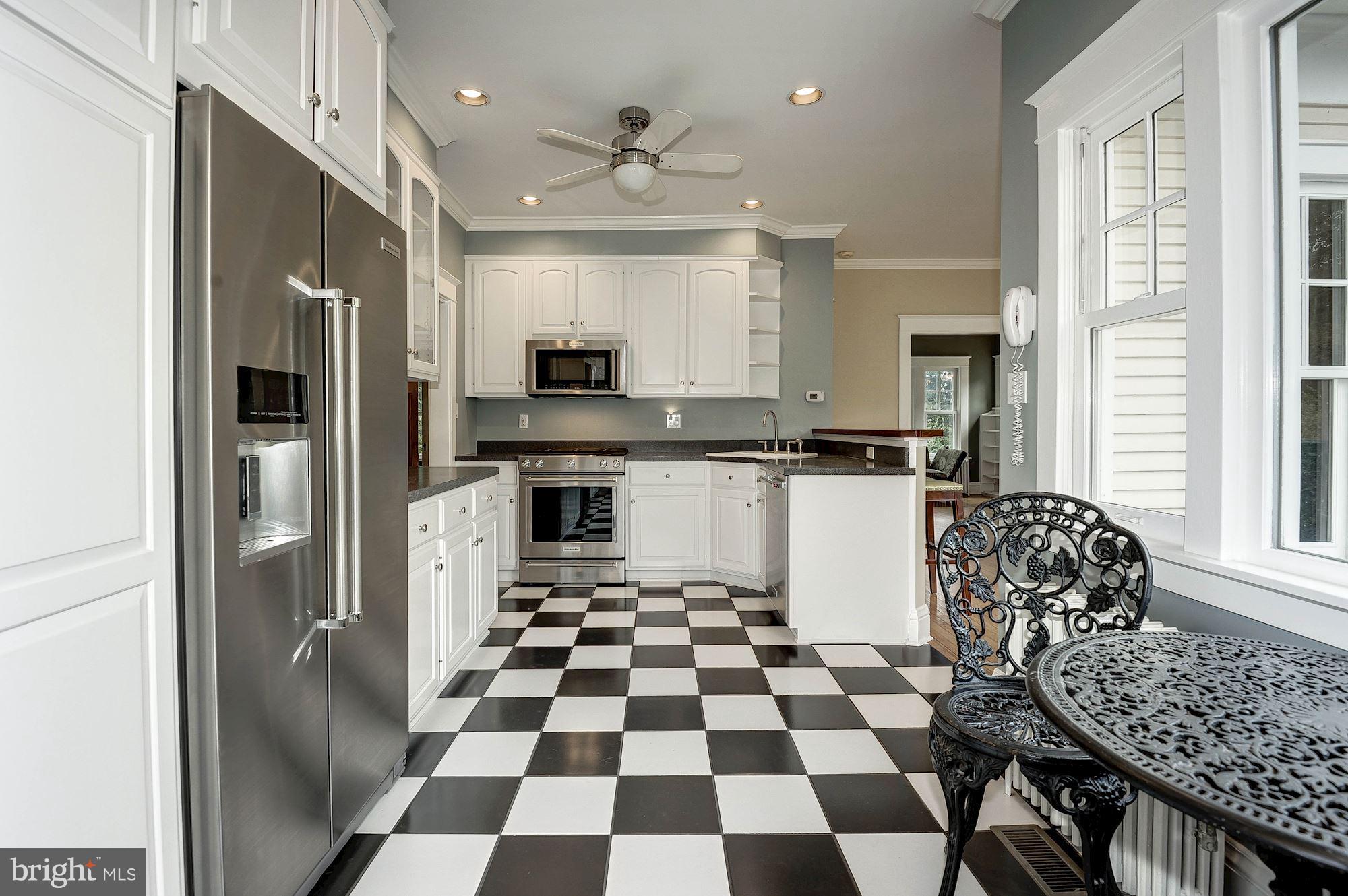 1213 Buchanan Street McLean, VA 22101 - Photo 9 of 30 a kitchen with a checkered floor and white cabinets