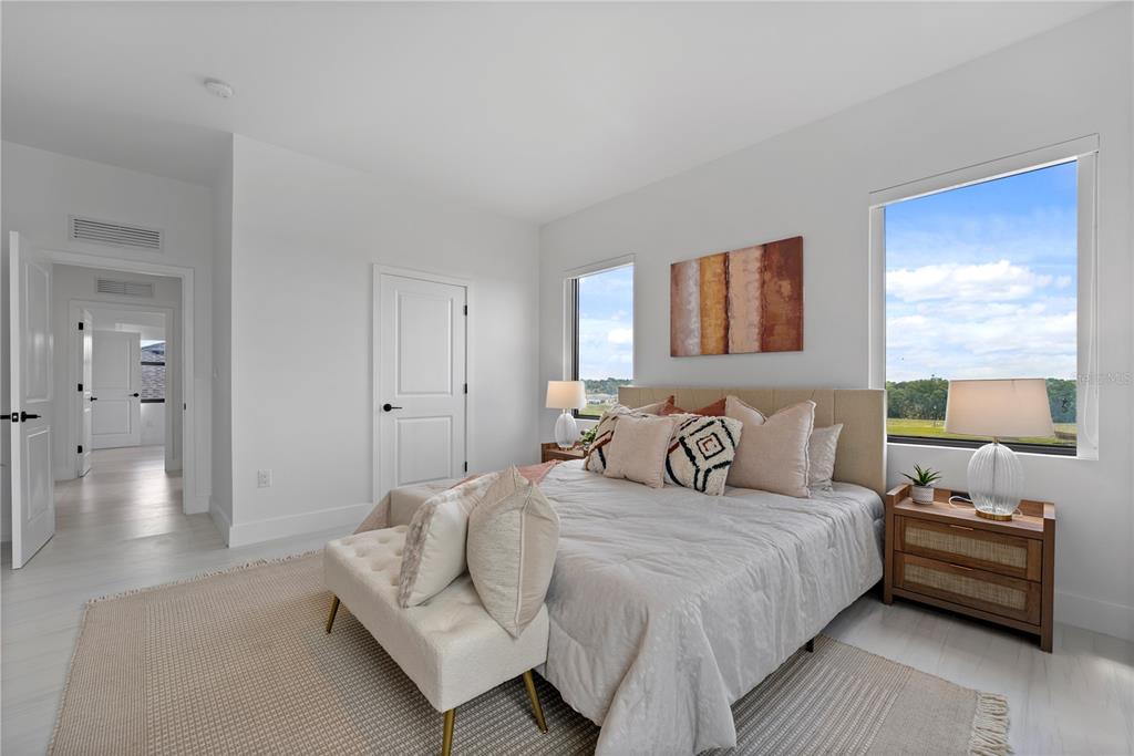 6299 Chorus Drive Mascotte, FL 34753 - Photo 12 of 24 a bedroom with a bed and wooden floor