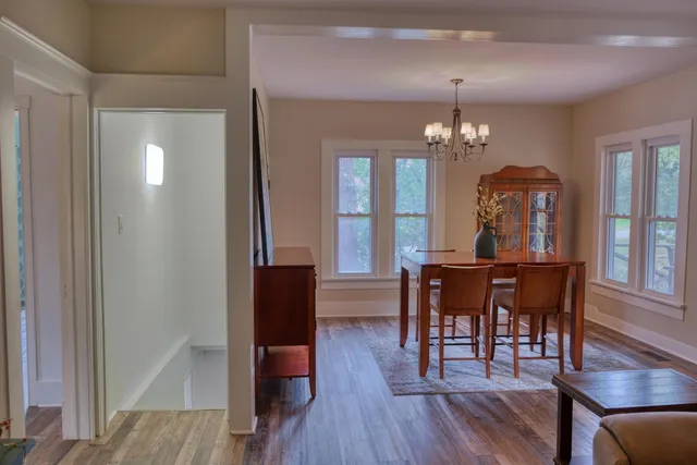 a view of a dining room with furniture and wooden floor