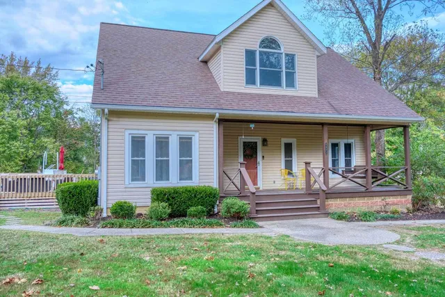 a front view of a house with garden and porch