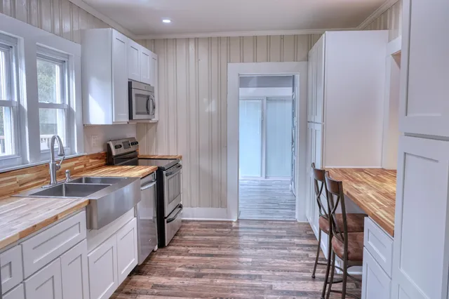 a kitchen with a wooden floor and a window
