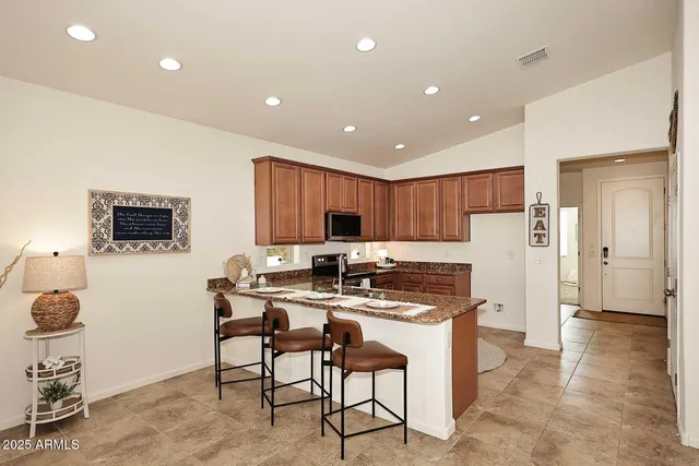 a kitchen with stainless steel appliances a refrigerator and a stove top oven
