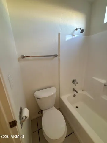 a bathroom with a toilet sink and shower