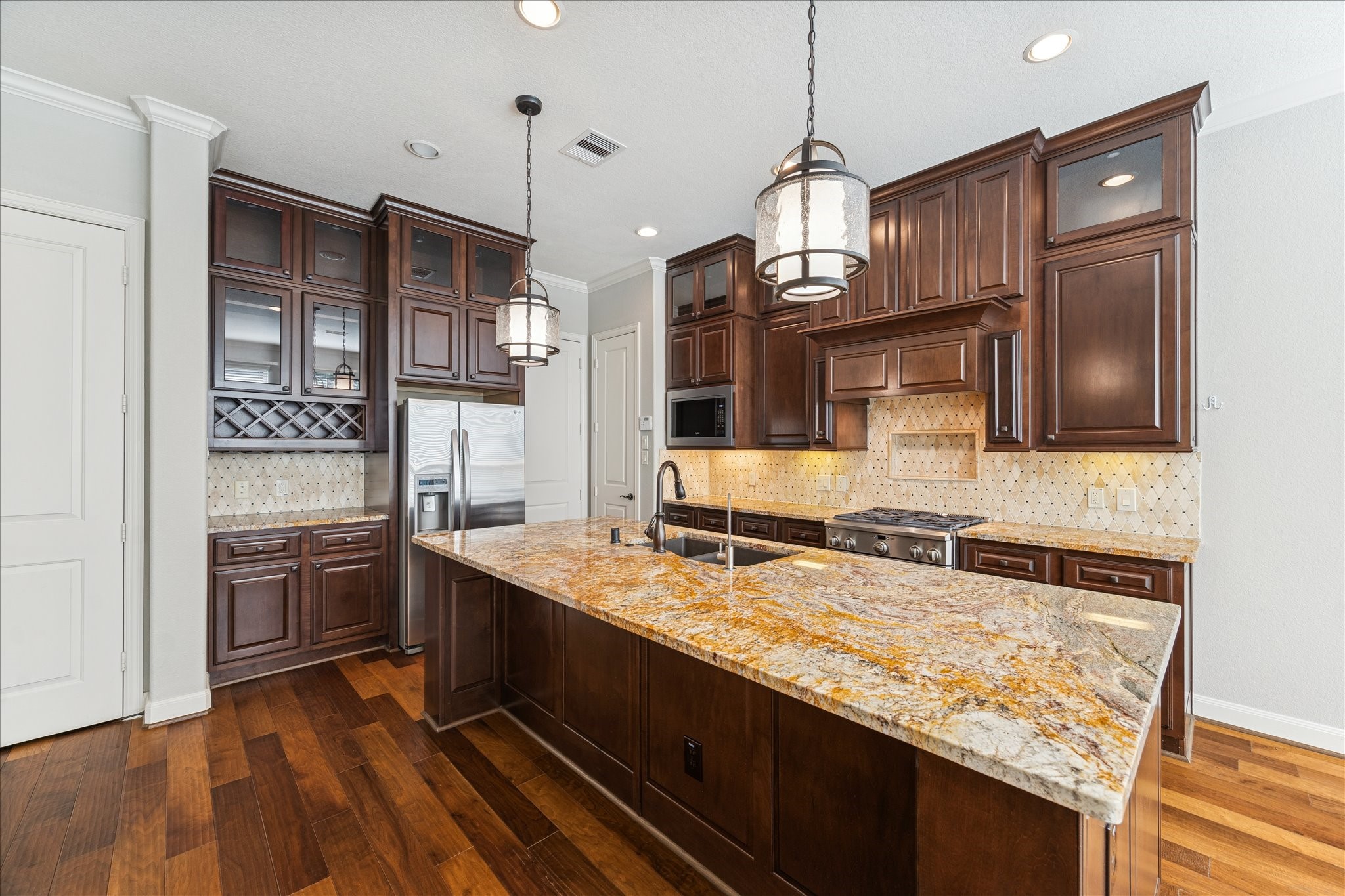43 Herons Flight Place Spring, TX 77389 - Photo 3 of 10 a kitchen with stainless steel appliances granite countertop a sink and a refrigerator