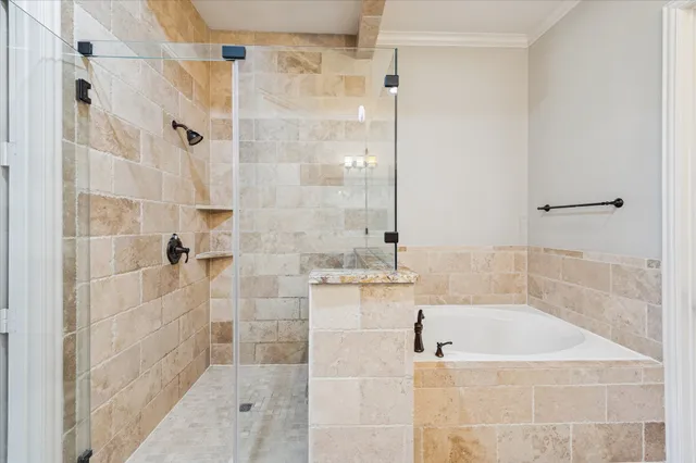 a bathroom with a bathtub and shower