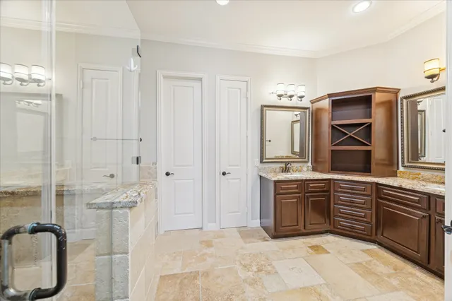 a spacious bathroom with a granite countertop sink mirror and