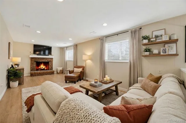 a living room with furniture and a fireplace