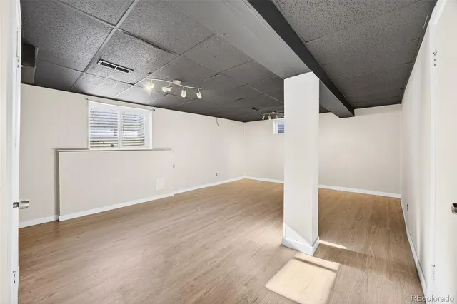 an empty room with wooden floor