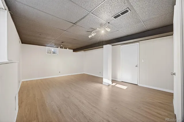 an empty room with wooden floor