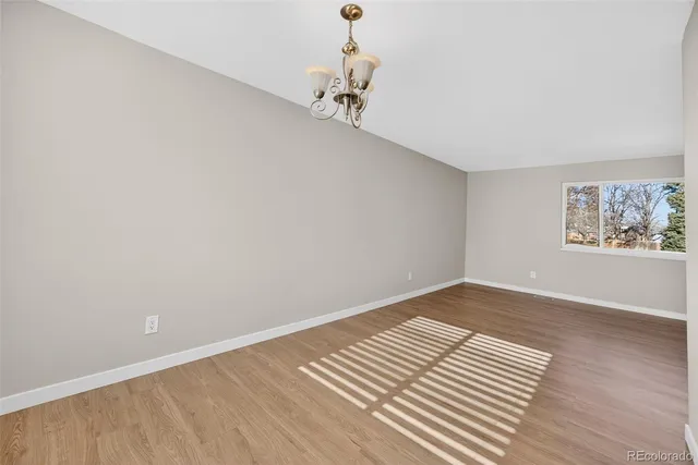 a view of a room with wooden floor and window