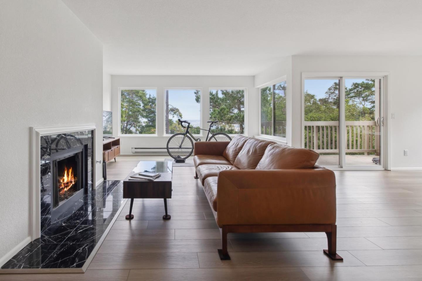 46 Shepherds Knoll Road Pebble Beach, CA 93953 - Photo 2 of 41 a living room with furniture a fireplace and large windows