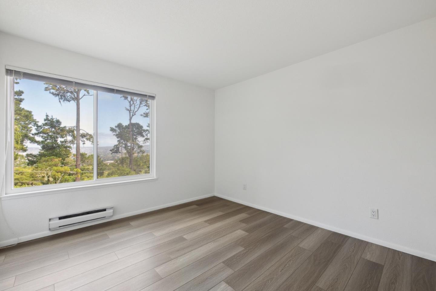 46 Shepherds Knoll Road Pebble Beach, CA 93953 - Photo 26 of 41 wooden floor in an empty room with a window