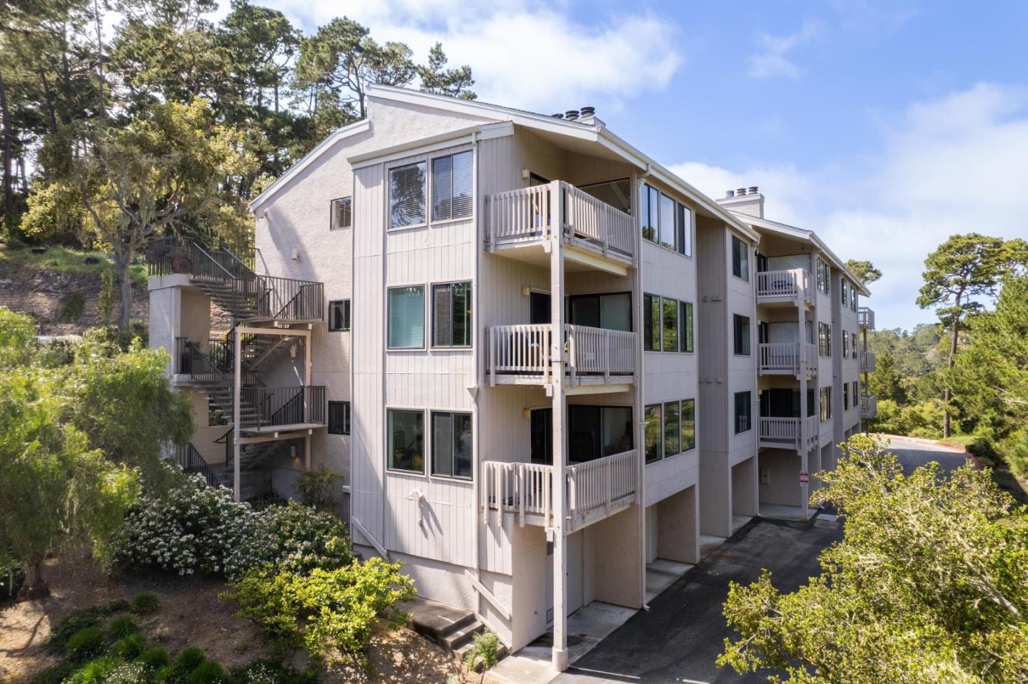 46 Shepherds Knoll Road Pebble Beach, CA 93953 - Photo 40 of 41 a view of white house with a yard and potted plants