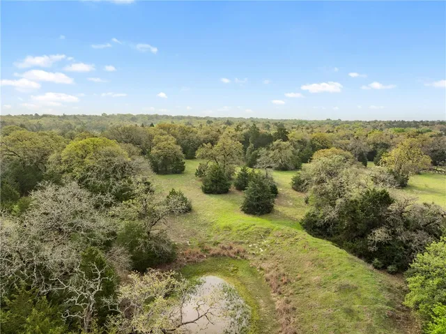 a view of a bunch of mountains in middle of green field