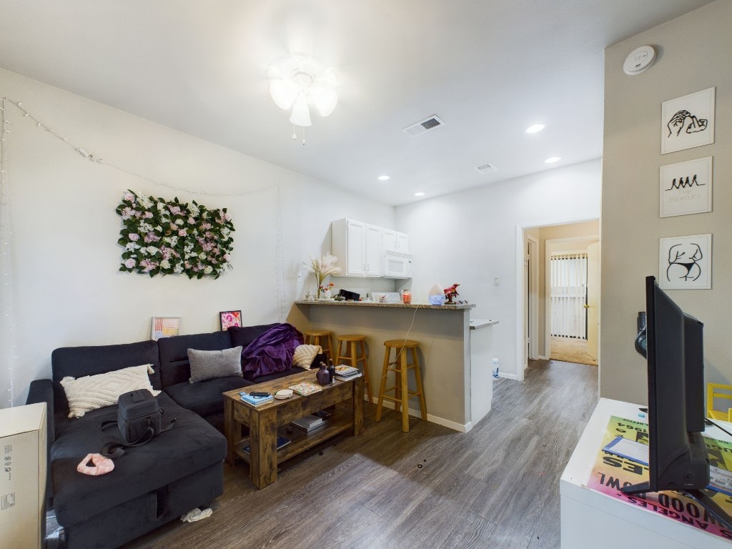 2815 Rio Grande Street, Unit 101 Austin, TX 78705 - Photo 9 of 15 a living room with furniture and a flat screen tv