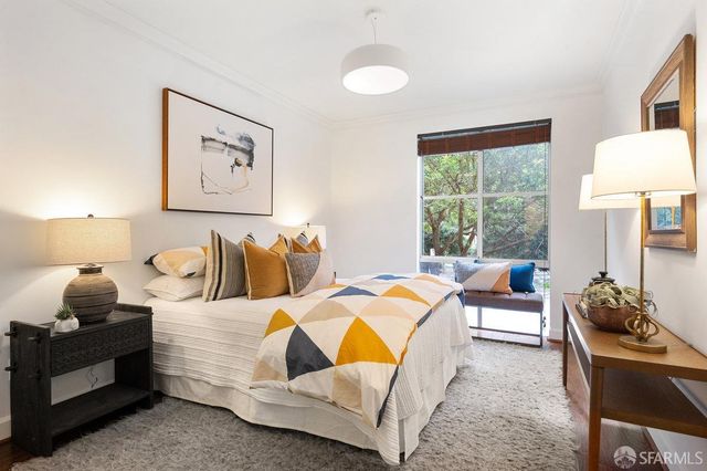 a bedroom with bed and a couch