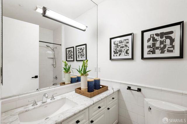 a bathroom with a granite countertop sink mirror and vanity