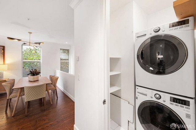 a view of a room with furniture and wooden floor
