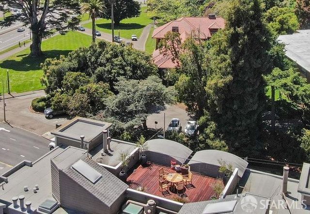an aerial view of a house with garden space and sitting area