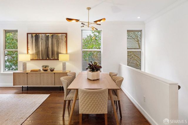 a view of a dining room with furniture window and wooden floor