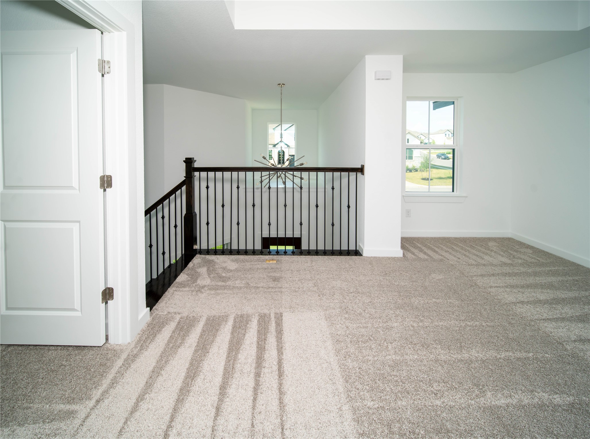 2029 Varese Path Leander, TX 78641 - Photo 20 of 32 a view of a hallway with wooden floor and stairs