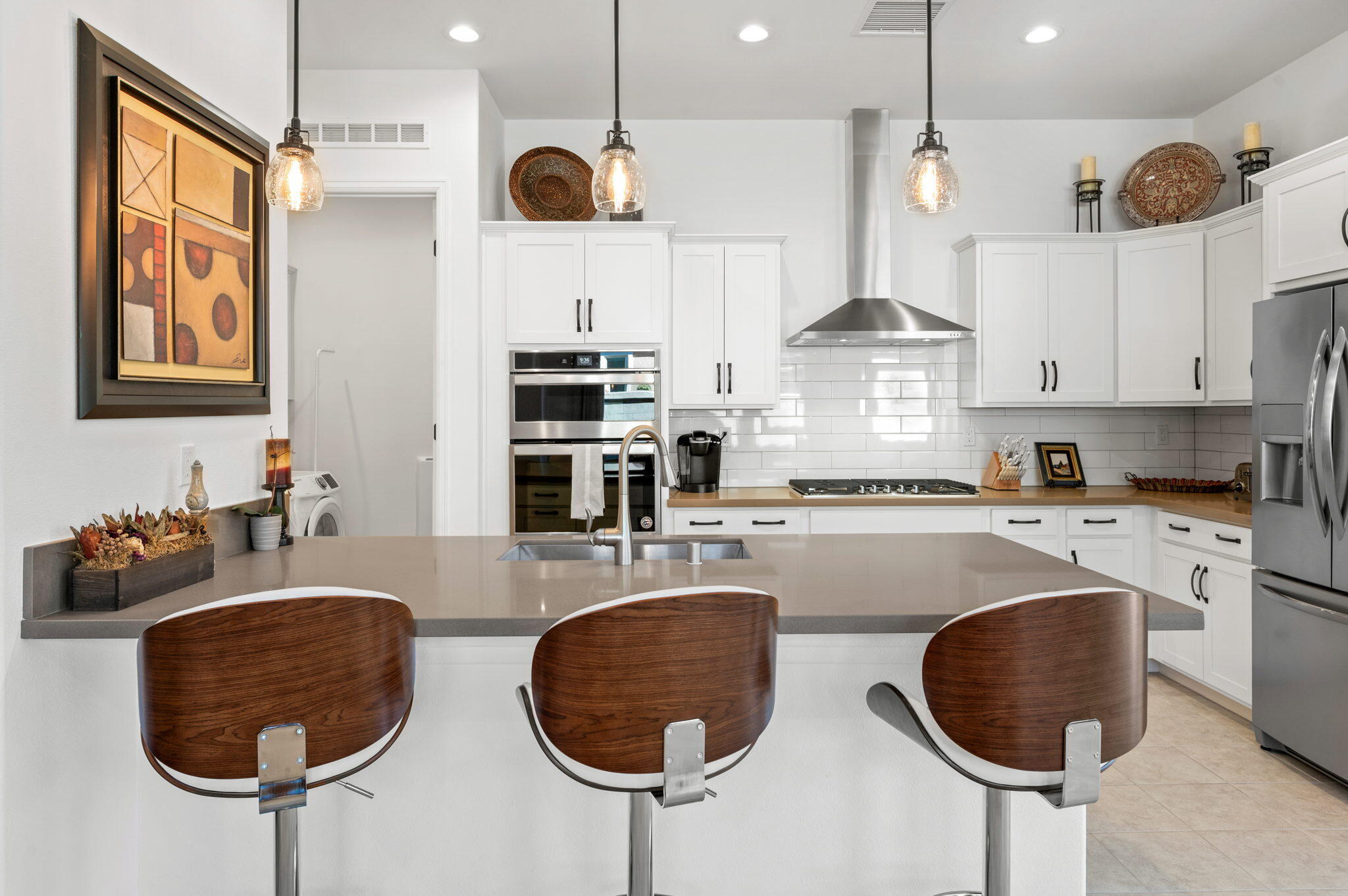 67 Cabernet Rancho Mirage, CA 92270 - Photo 11 of 41 a kitchen with stainless steel appliances granite countertop a stove a sink a cabinets and chairs