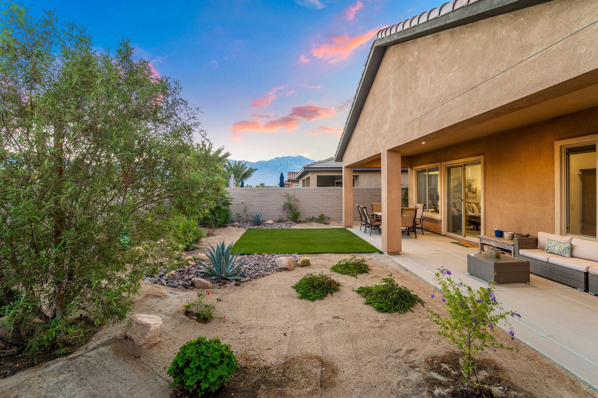 67 Cabernet Rancho Mirage, CA 92270 - Photo 36 of 41 a view of a patio with table and chairs potted plants and large tree