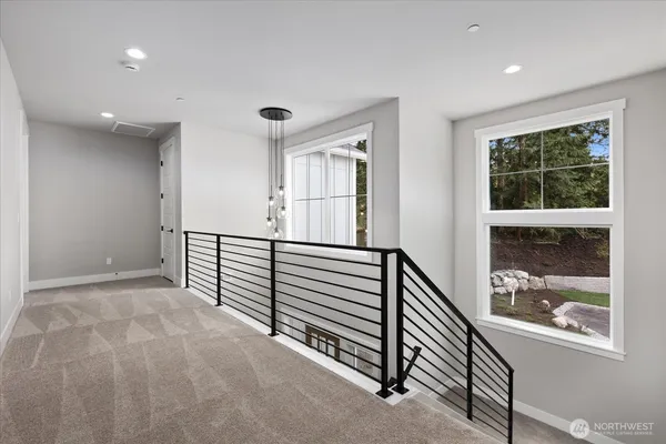 a view of a hallway with window and stairs