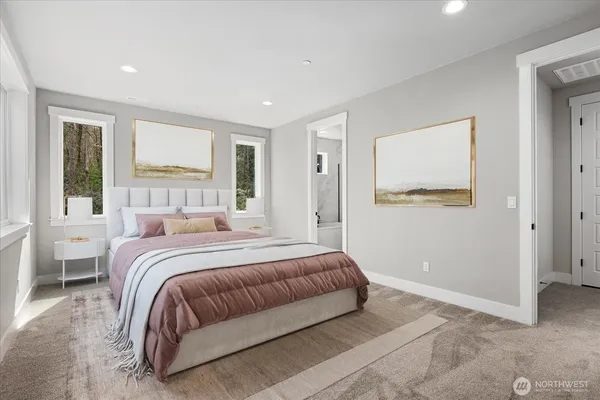 a bedroom with a large bed and a window