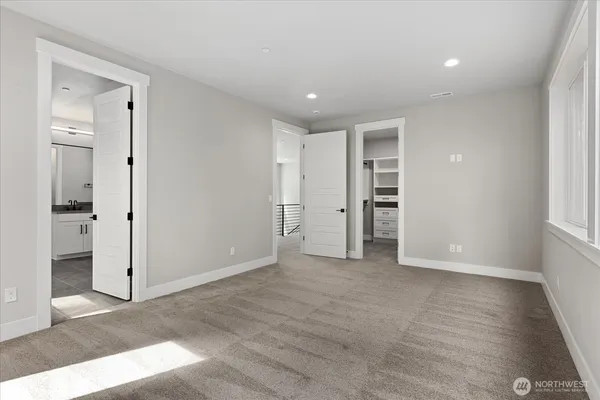 an empty room with closet and a window