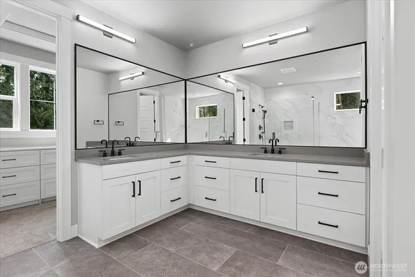 a spacious bathroom with a granite countertop sink mirror and double