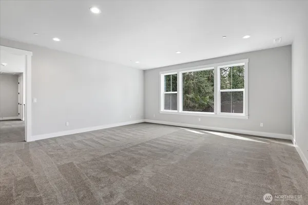 an empty room with large windows