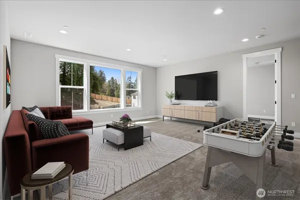 a living room with furniture a flat screen tv and a window