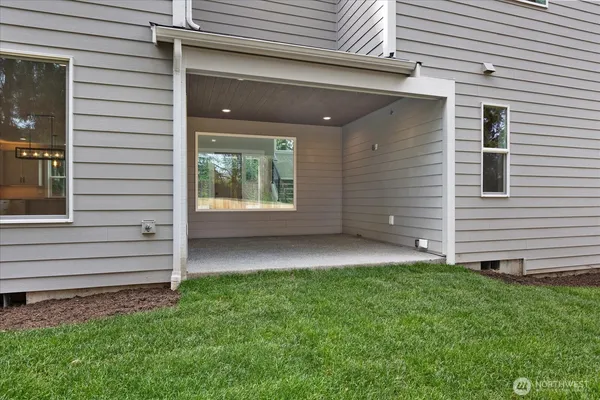 a front view of a house with a garden and yard