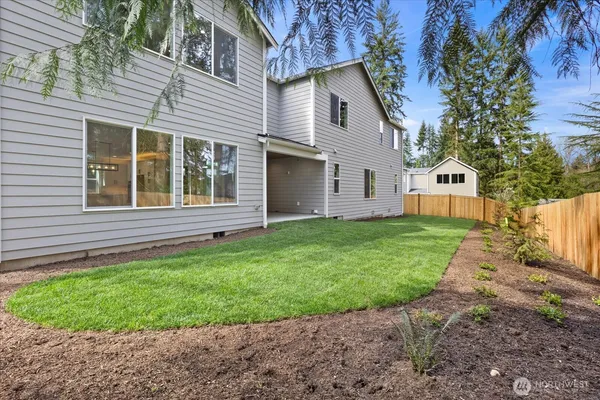 a view of yard with trees in the background