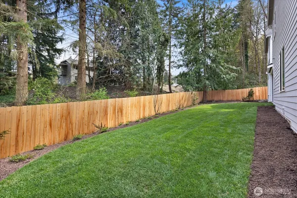 a front view of a house with a garden and yard
