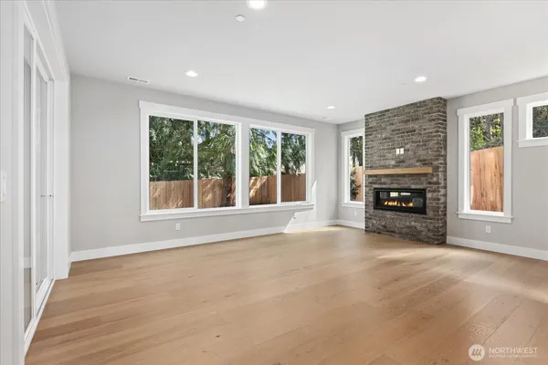 an empty room with furniture and a fireplace
